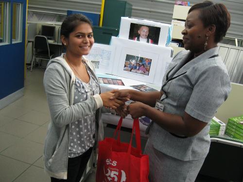  Alicia Cameron, Campus Manager, Trincity, presents Britney Williams with her SBCS token.